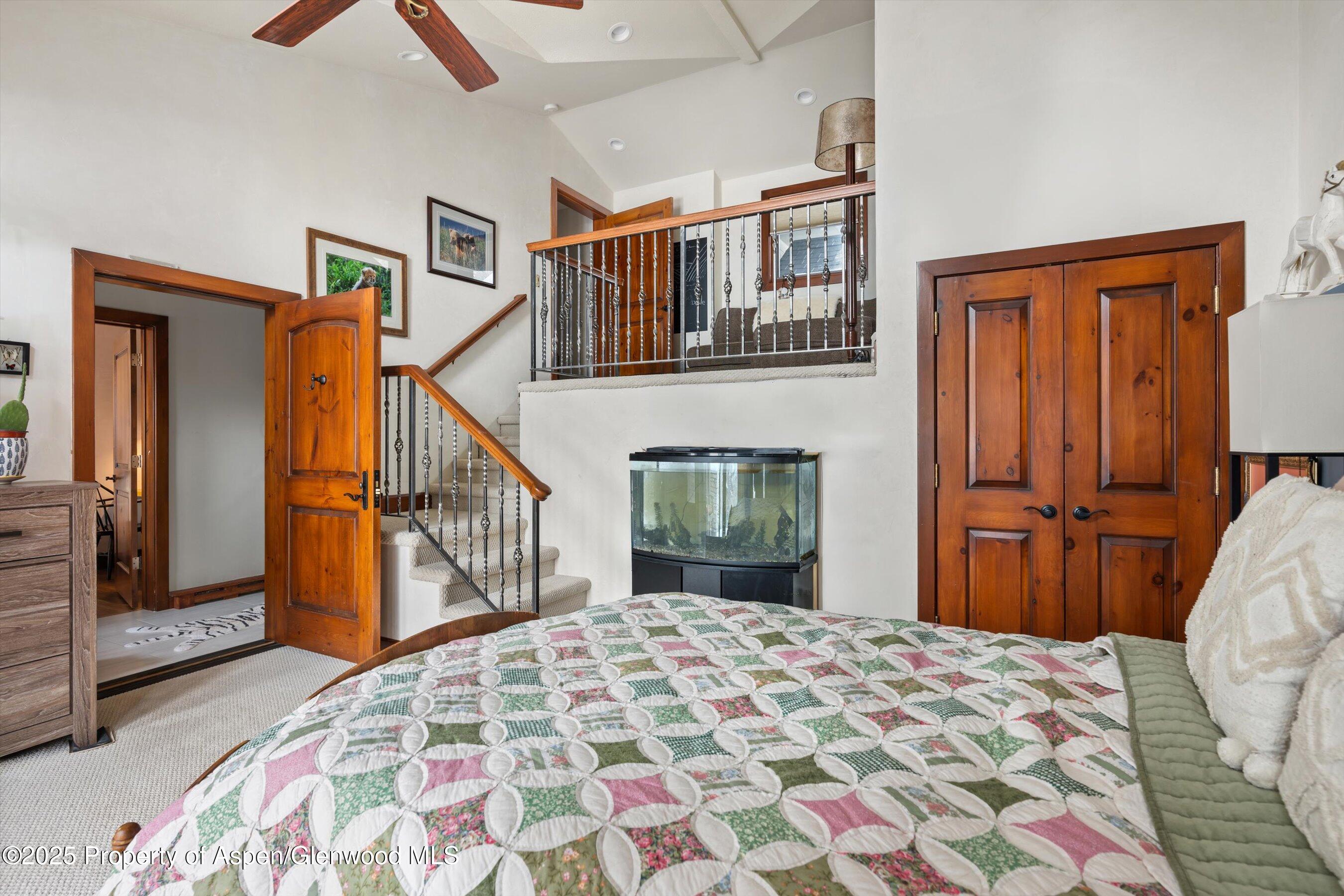 516 Sinclair Road Snowmass Village, CO 81615 - Photo 32 of 37 a bedroom with a bed and a chandelier