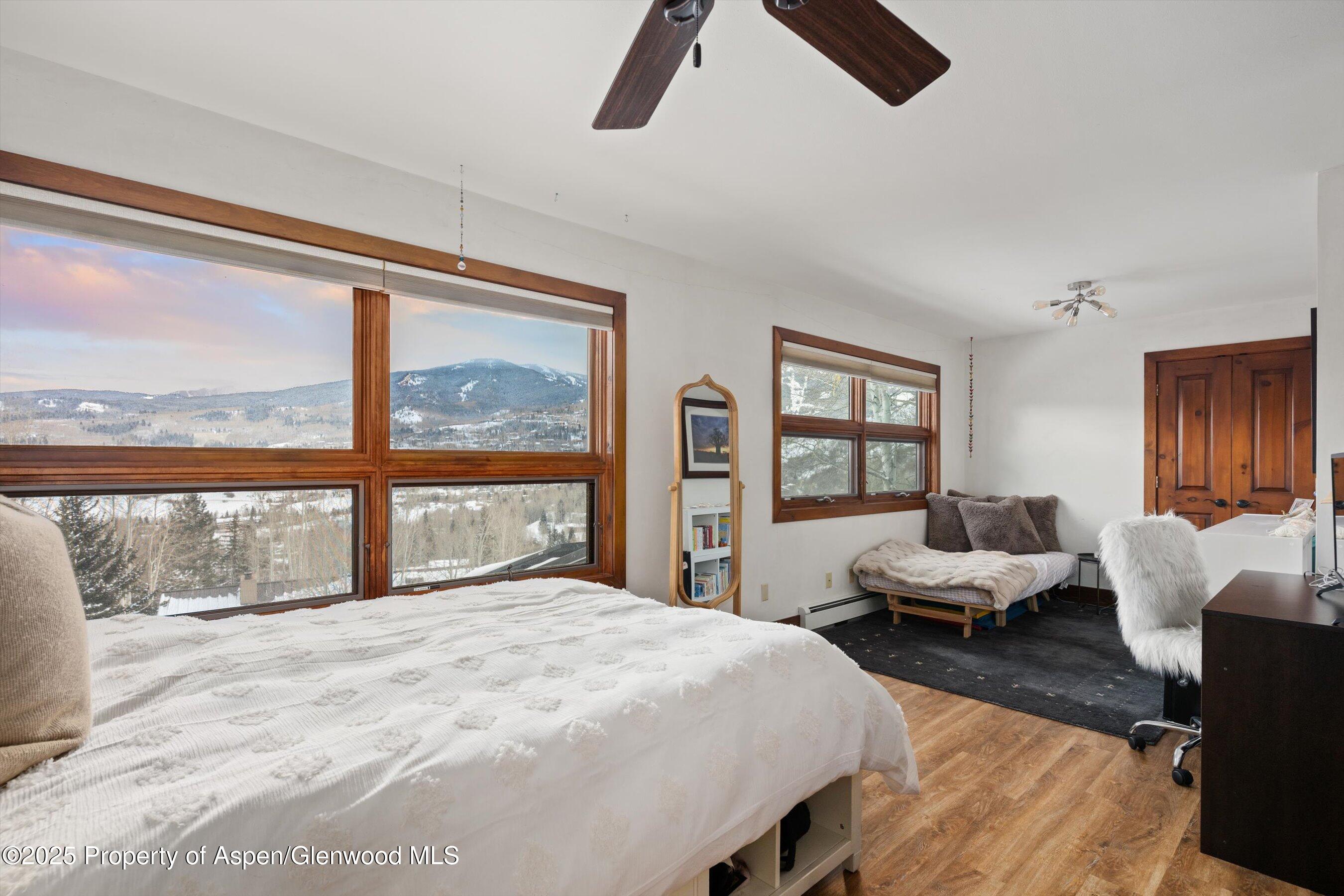 516 Sinclair Road Snowmass Village, CO 81615 - Photo 34 of 37 a bedroom with a bed and glass window