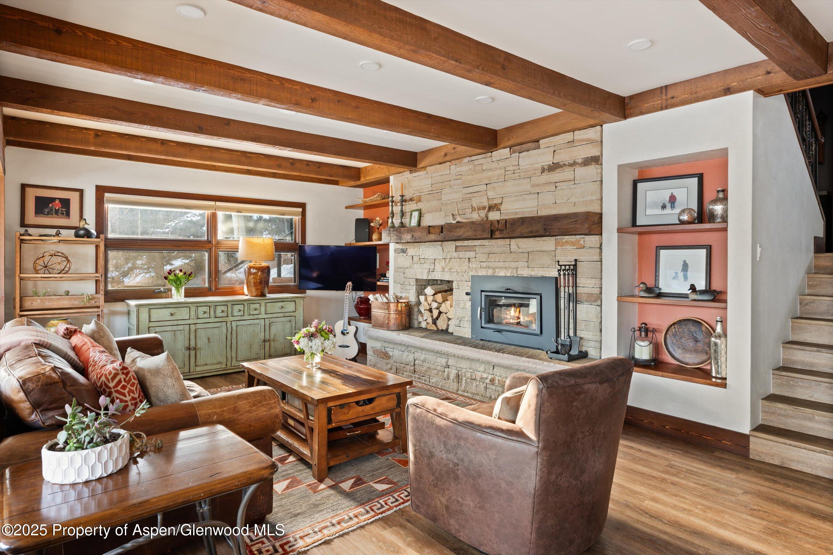516 Sinclair Road Snowmass Village, CO 81615 - Photo 8 of 37 a living room with fireplace furniture and a floor to ceiling window