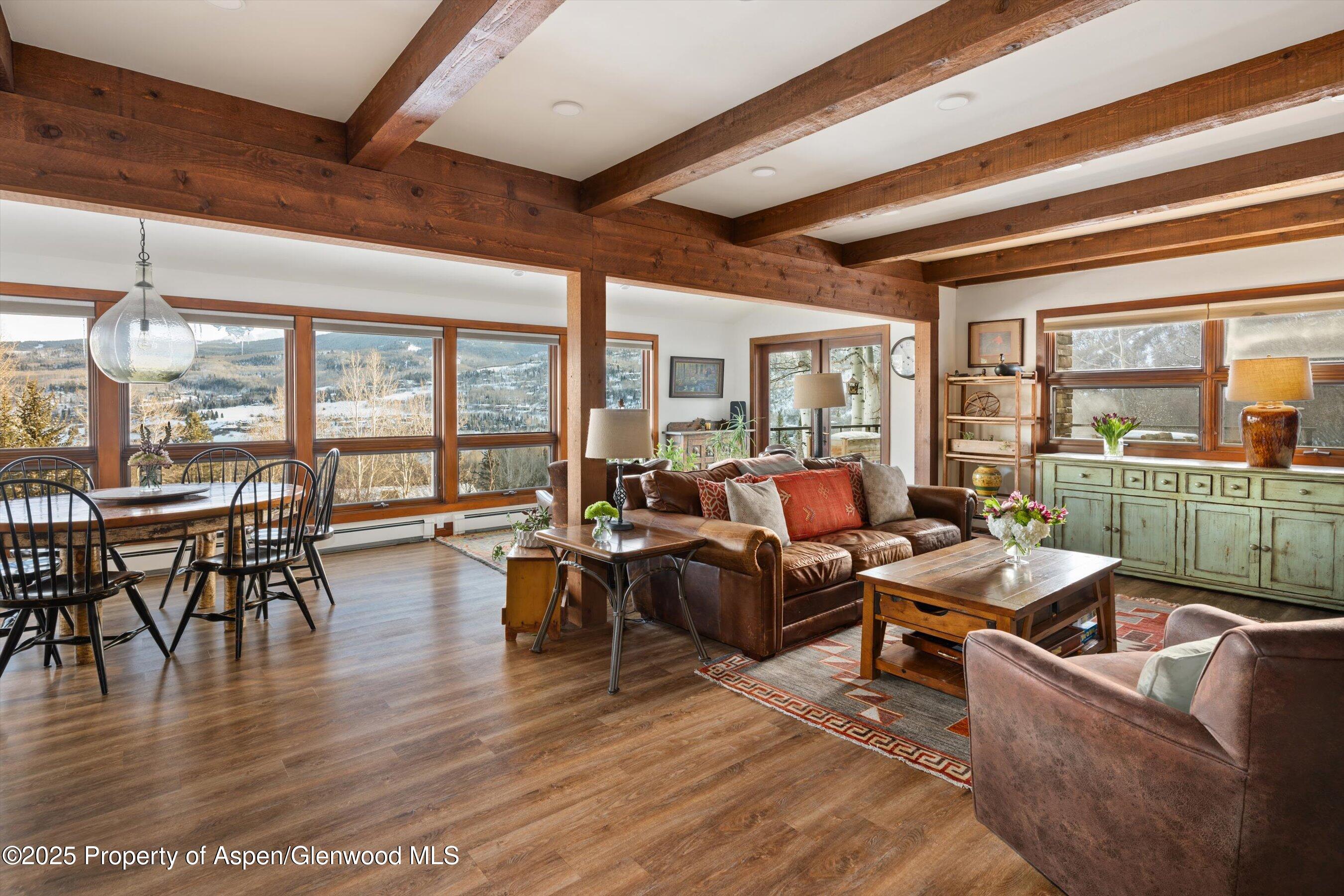 516 Sinclair Road Snowmass Village, CO 81615 - Photo 9 of 37 a living room with furniture large window and wooden floor
