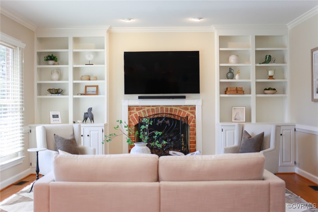 107 Muirfield Williamsburg, VA 23188 - Photo 11 of 36 a living room with furniture a flat screen tv and a fireplace
