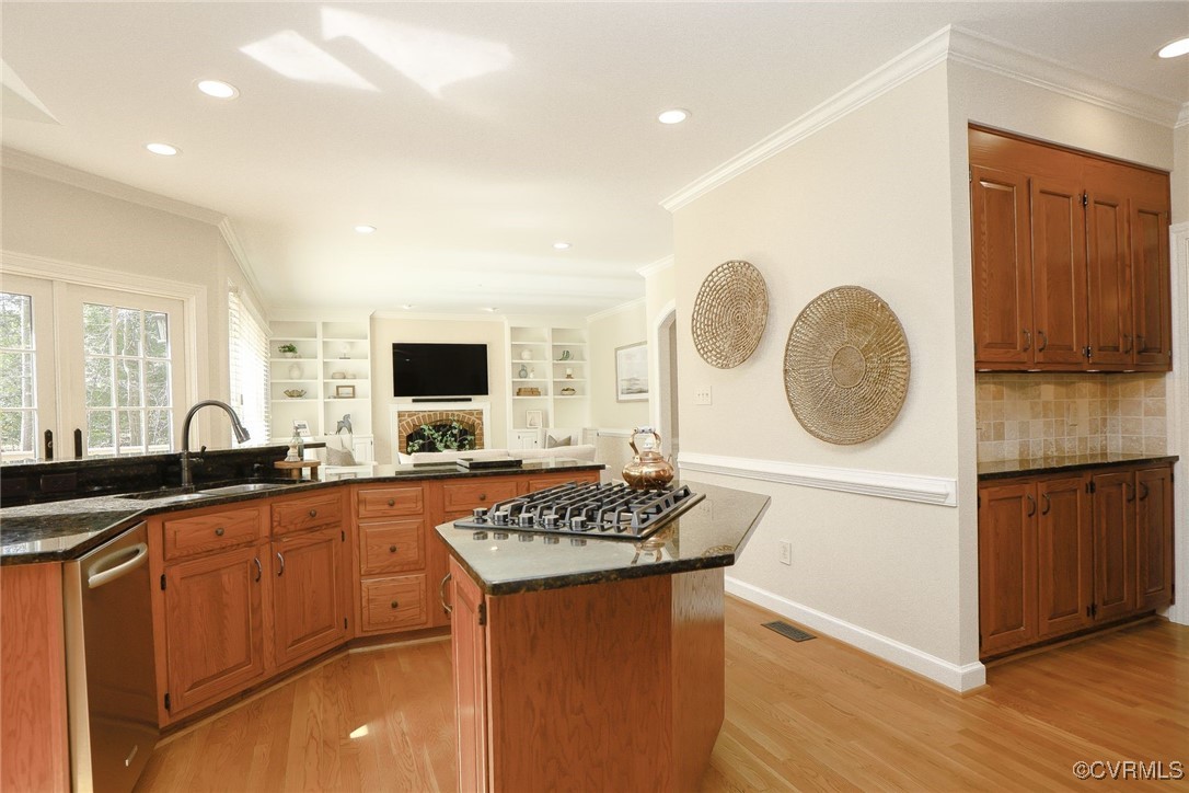 107 Muirfield Williamsburg, VA 23188 - Photo 14 of 36 a kitchen with stainless steel appliances granite countertop a sink and a stove with wooden floor