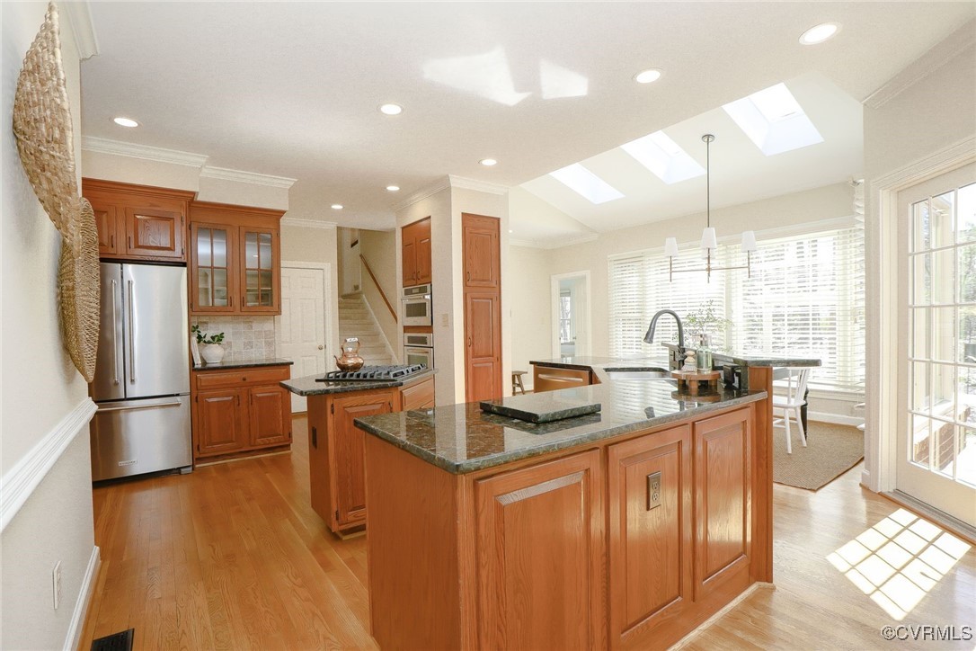 107 Muirfield Williamsburg, VA 23188 - Photo 15 of 36 a kitchen with stainless steel appliances granite countertop a sink stove and refrigerator