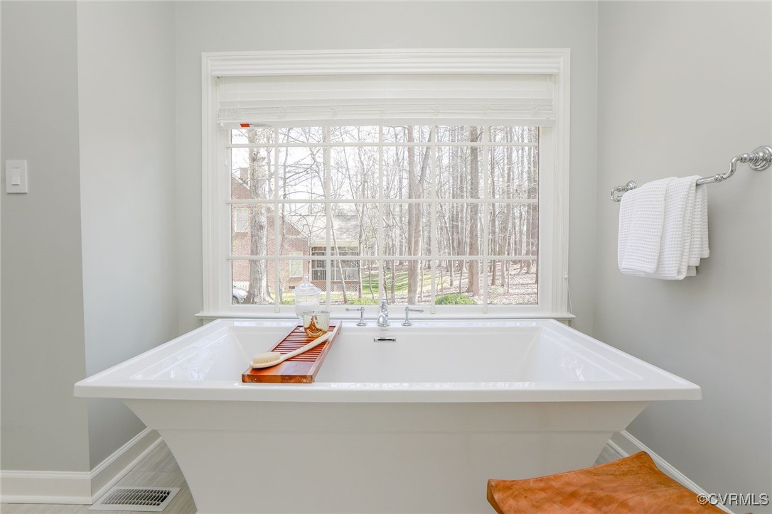 107 Muirfield Williamsburg, VA 23188 - Photo 21 of 36 a bathroom with a bathtub and a window