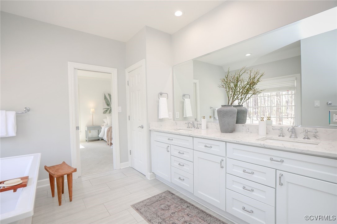 107 Muirfield Williamsburg, VA 23188 - Photo 22 of 36 a en suite bathroom with double sink and a mirror