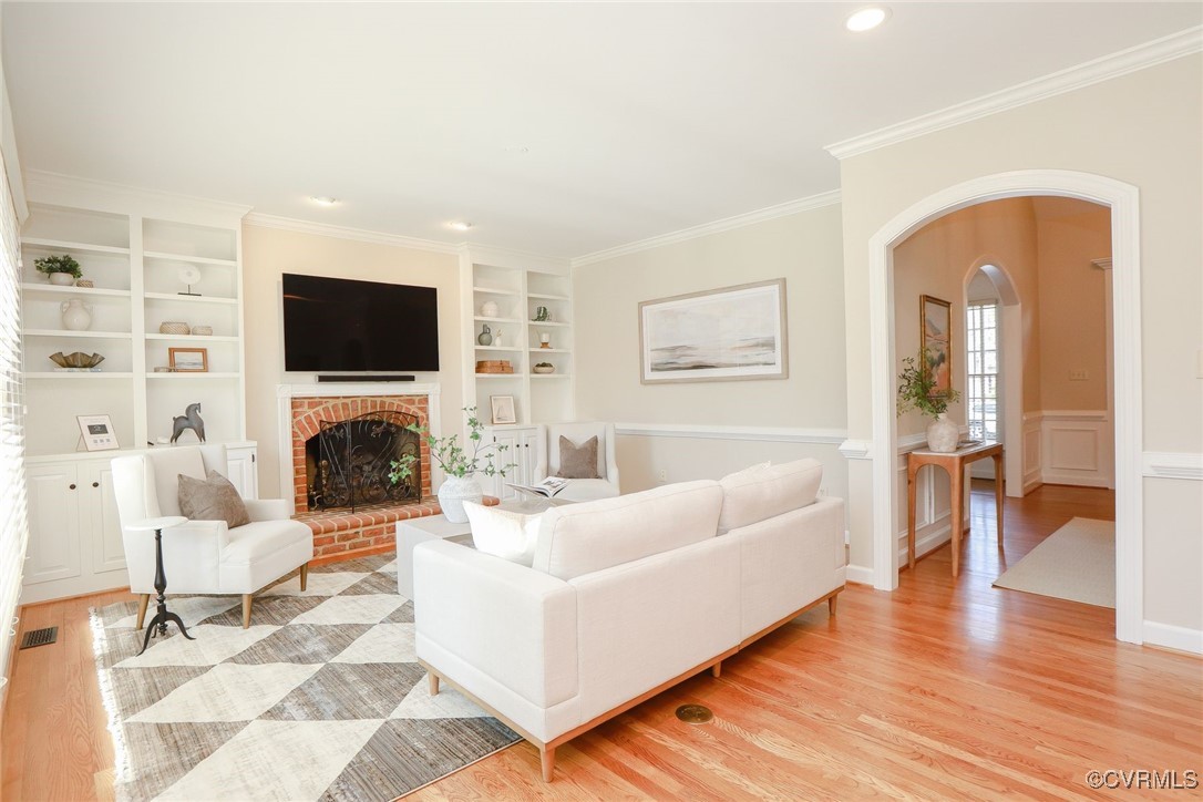 107 Muirfield Williamsburg, VA 23188 - Photo 9 of 36 a living room with furniture a flat screen tv and a fireplace
