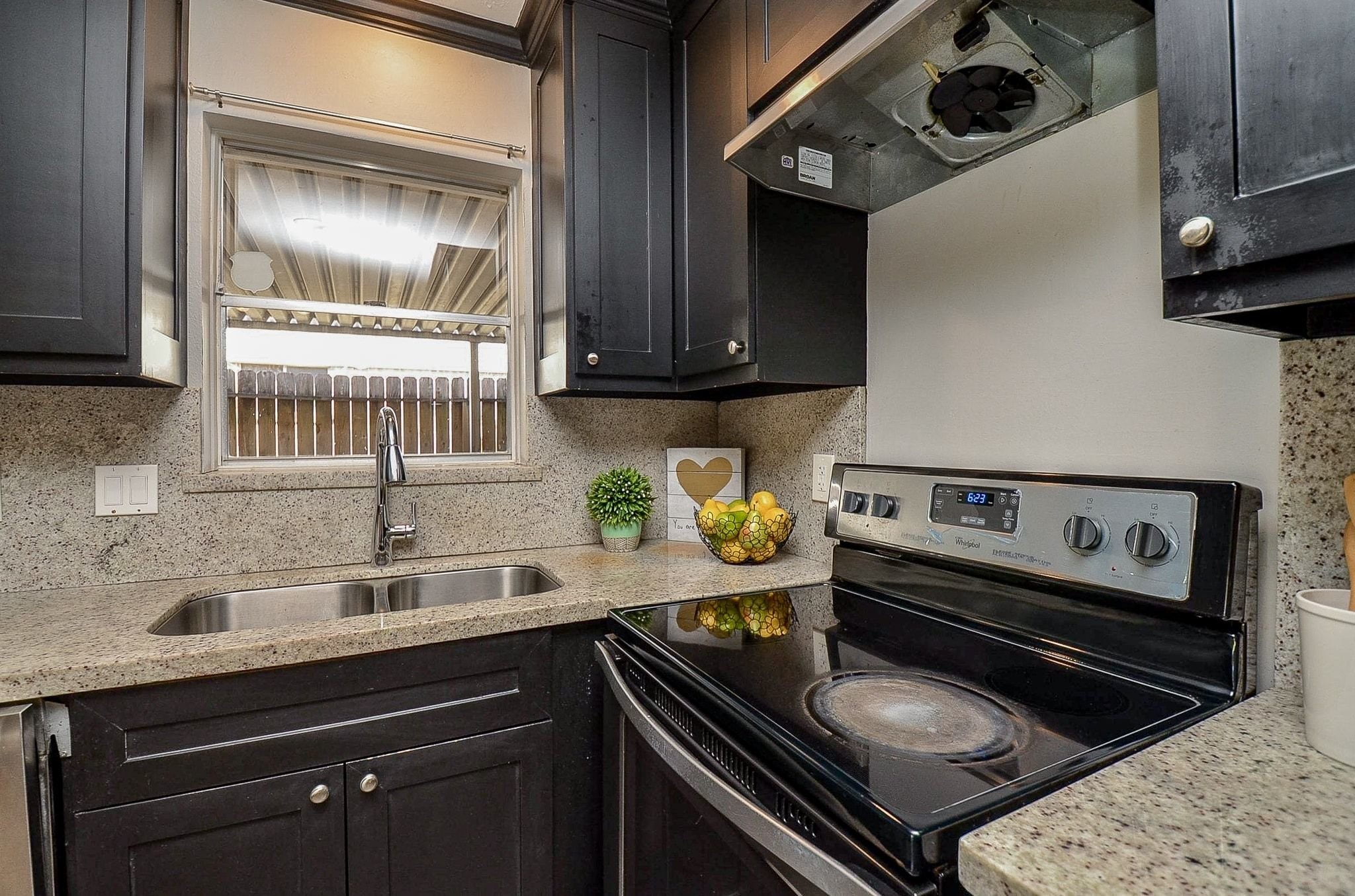 9215 Sharpcrest Street Houston, TX 77036 - Photo 10 of 31 a kitchen with a stove and a sink