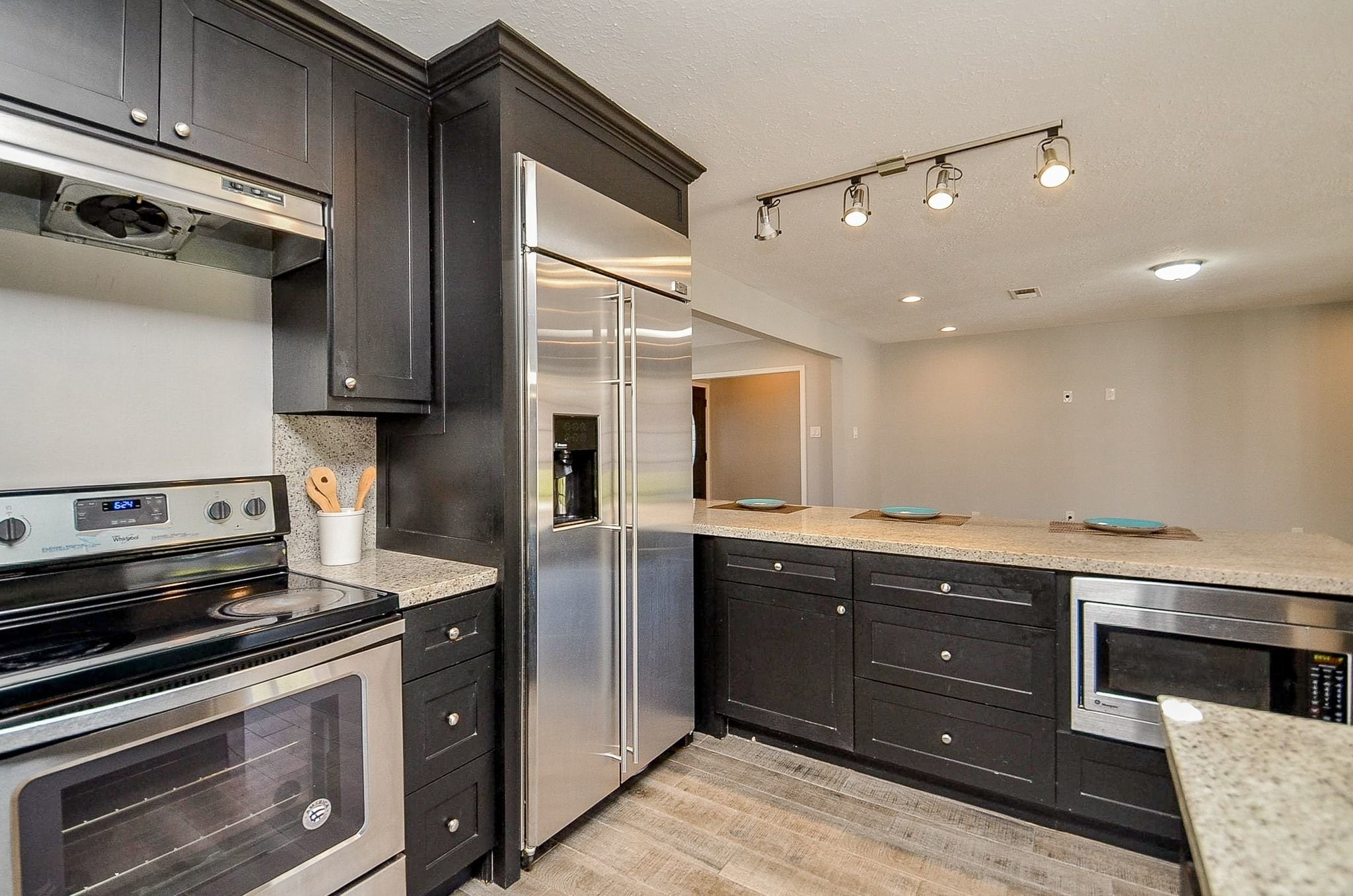 9215 Sharpcrest Street Houston, TX 77036 - Photo 12 of 31 a kitchen with a stove and a microwave