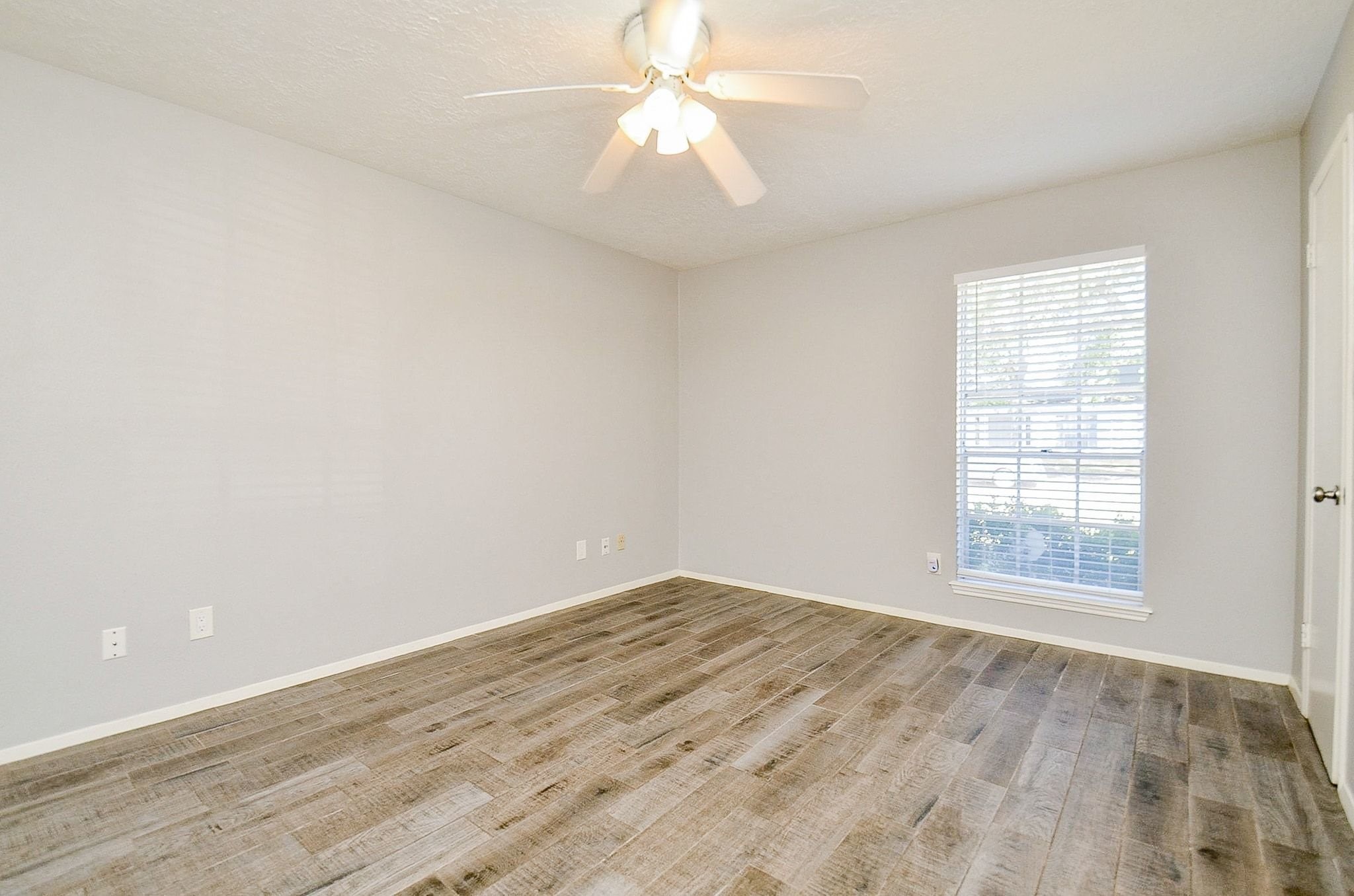 9215 Sharpcrest Street Houston, TX 77036 - Photo 15 of 31 an empty room with chandelier fan and windows