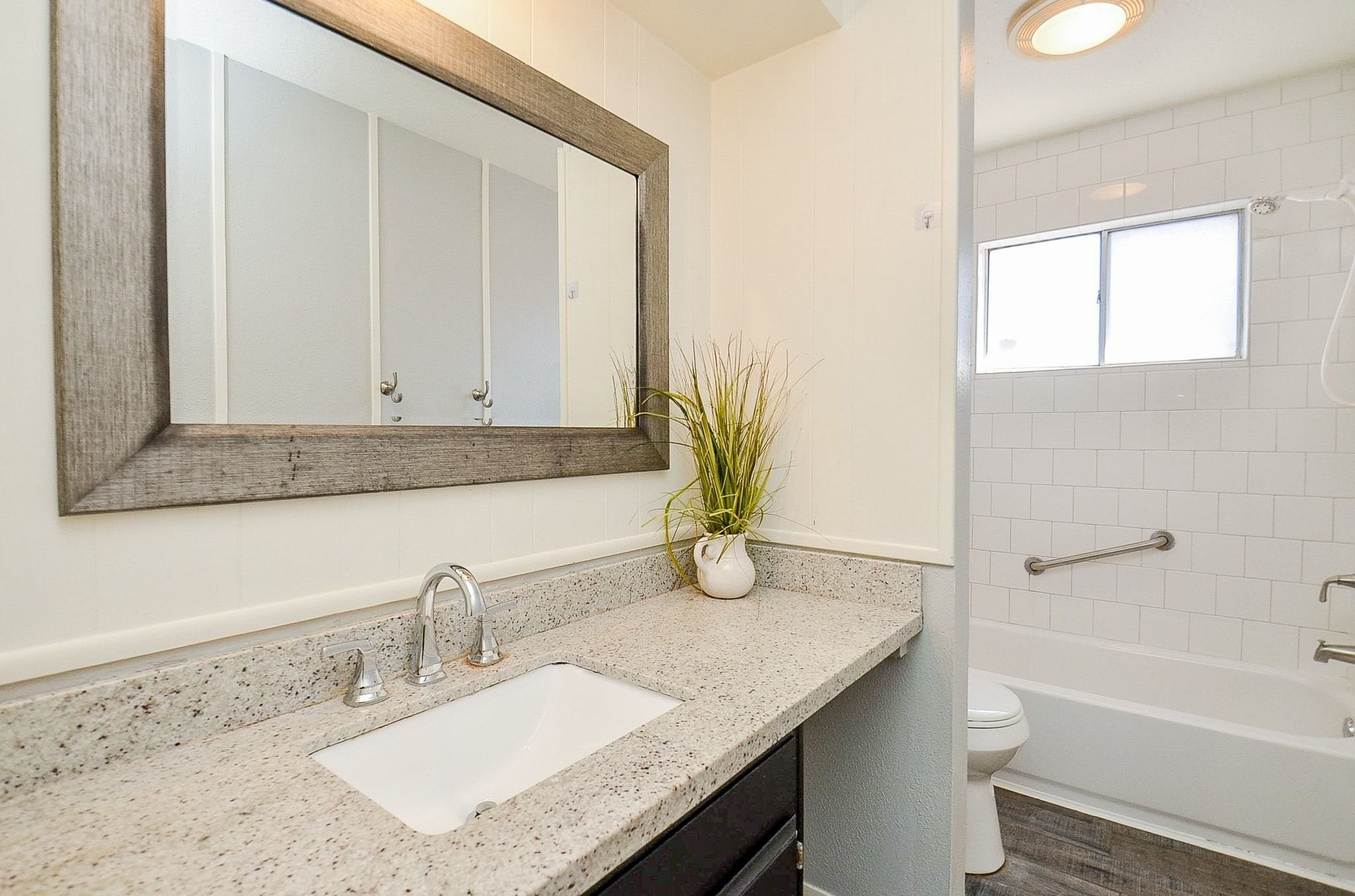 9215 Sharpcrest Street Houston, TX 77036 - Photo 18 of 31 a bathroom with a granite countertop sink a toilet and bathtub