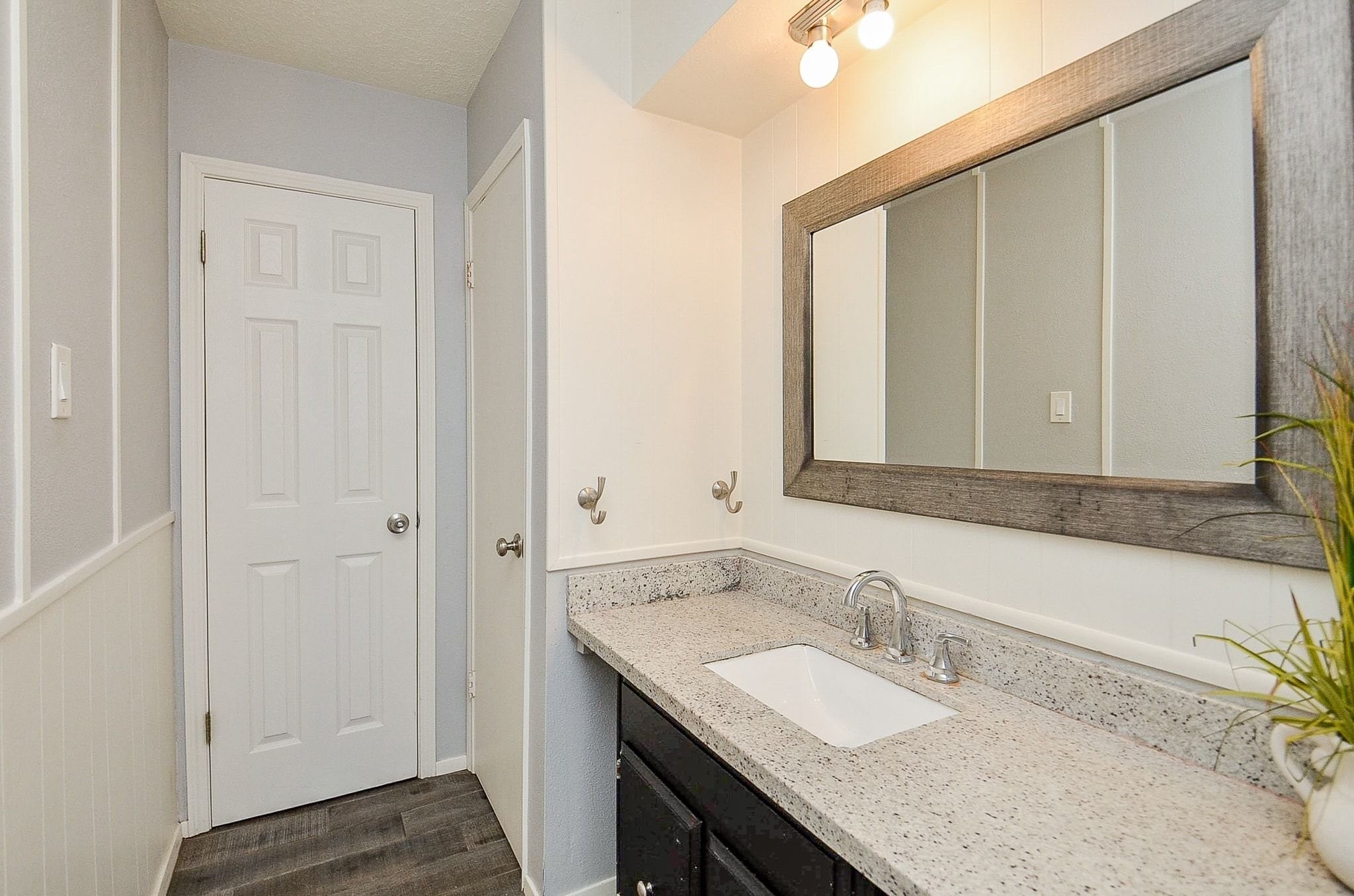 9215 Sharpcrest Street Houston, TX 77036 - Photo 19 of 31 a bathroom with a granite countertop sink and a mirror