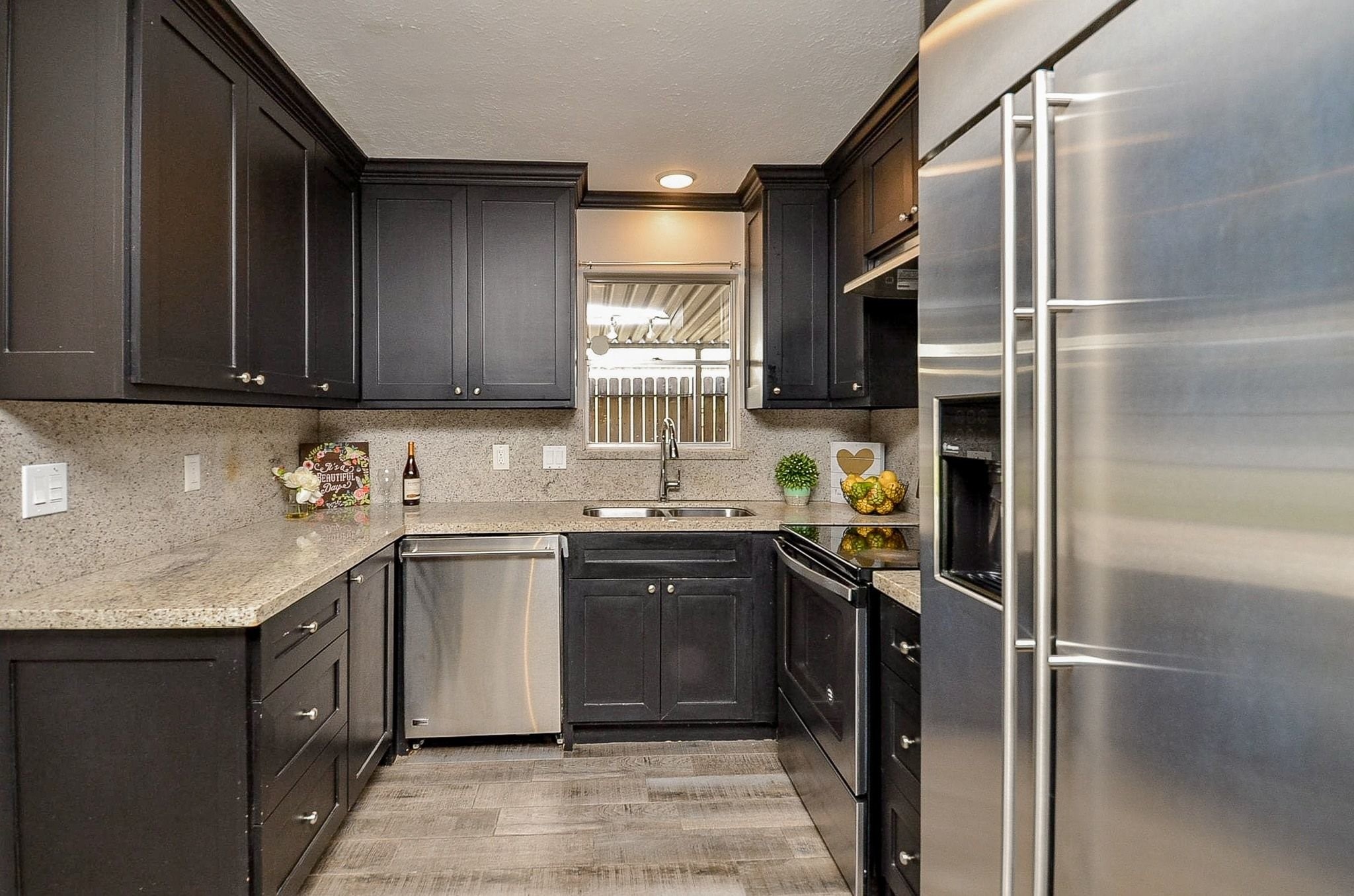 9215 Sharpcrest Street Houston, TX 77036 - Photo 9 of 31 a kitchen with stainless steel appliances granite countertop a sink stove and refrigerator