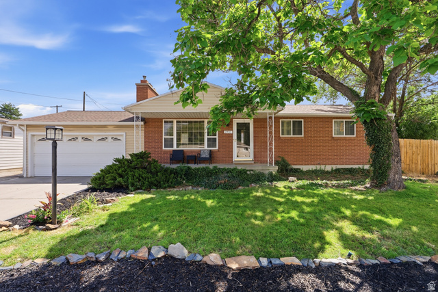 7795 South 1000 East Midvale, UT 84047 - Photo 1 of 42 Brick exterior with a gabled roofline and attached two-car garage