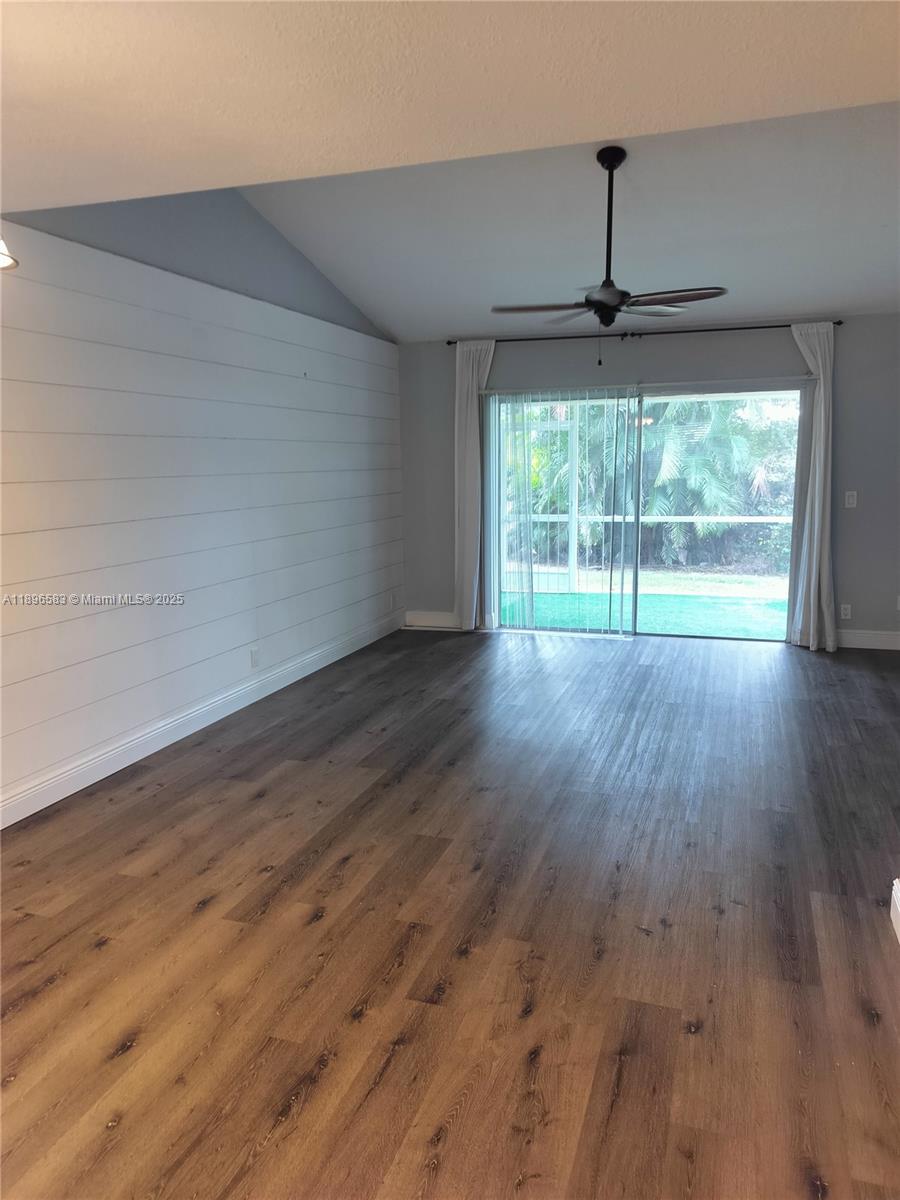 Jupiter Village II Jupiter, FL 33458 - Photo 4 of 9 a view of empty room with wooden floor ceiling fan and window