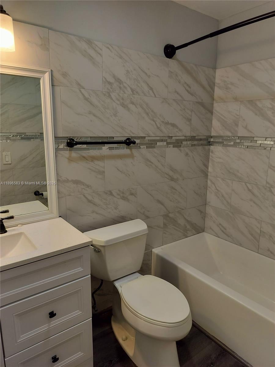 Jupiter Village II Jupiter, FL 33458 - Photo 8 of 9 a bathroom with a toilet and a shower