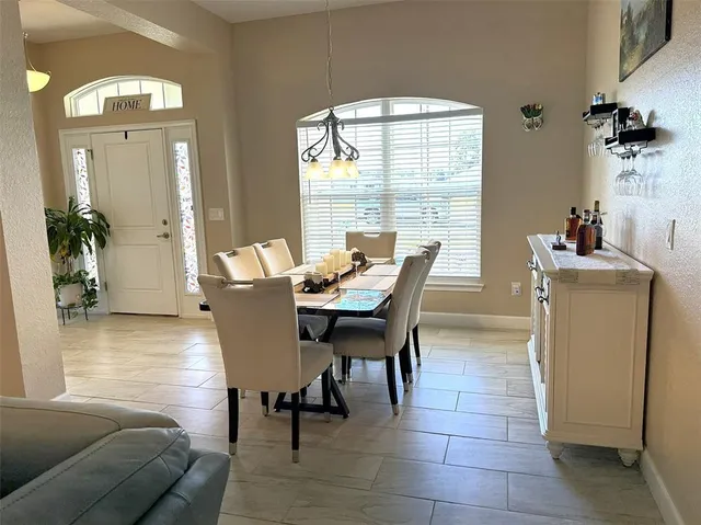 a dining room with furniture and window