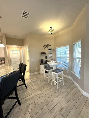 a view of a dining room with furniture window and outside view