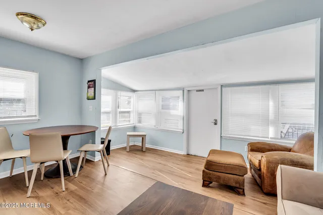 a living room with furniture a large window and a table
