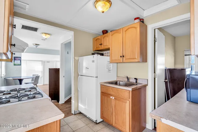 a kitchen with refrigerator and stove