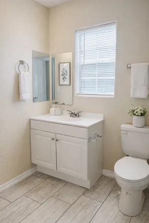 a bathroom with a toilet sink and mirror
