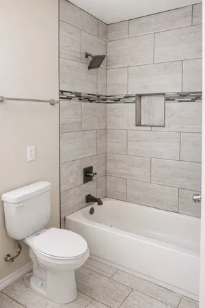 a bathroom with a toilet and shower