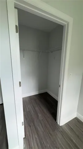 an empty room with wooden floor