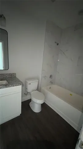 a bathroom with a toilet a sink and bathtub