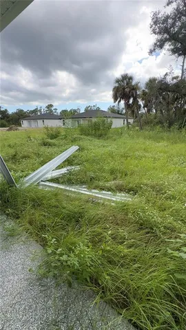a view of a field with an trees in the background