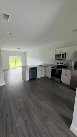 a view of kitchen and wooden floor