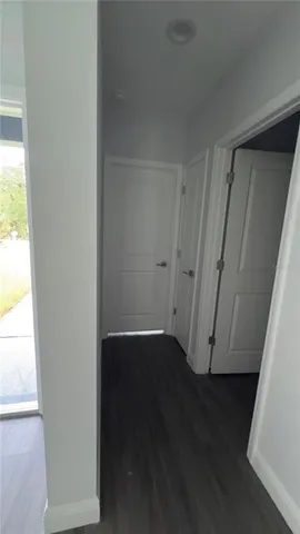 an empty room with wooden floor and sliding door