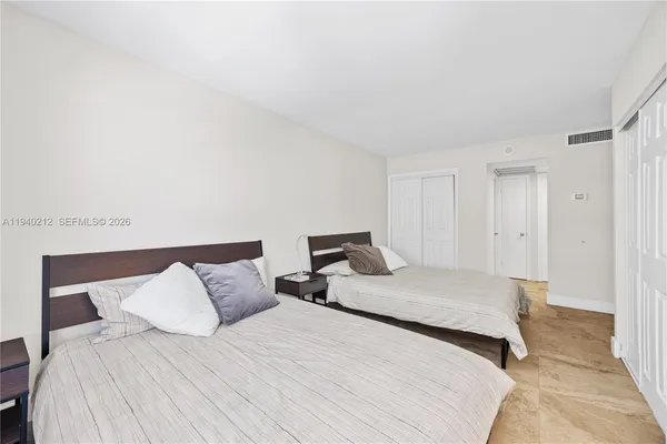 a bedroom with a bed and a night stand