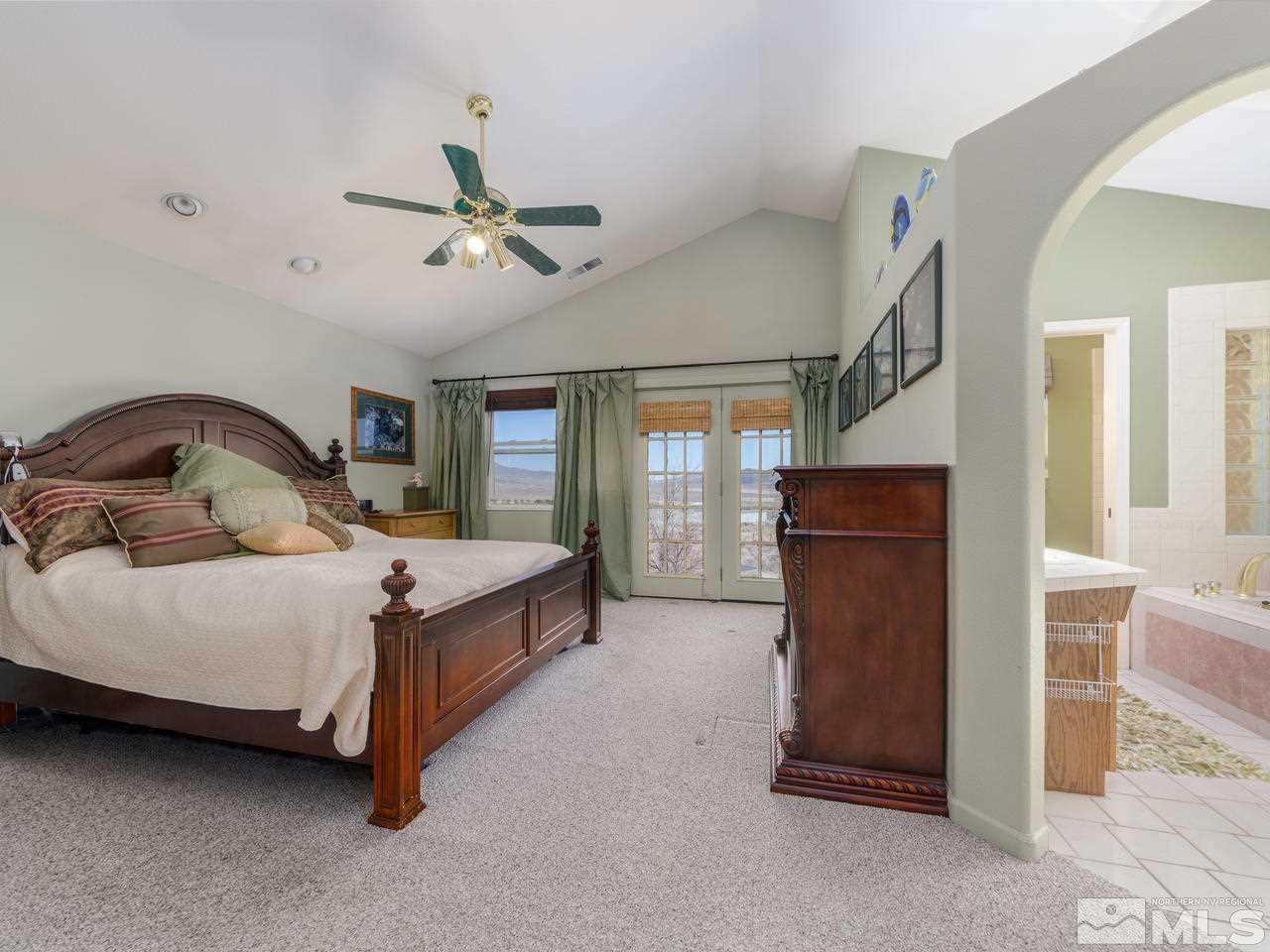 10315 Placerville Road Reno, NV 89508 - Photo 11 of 25 a bedroom with a bed and a chandelier
