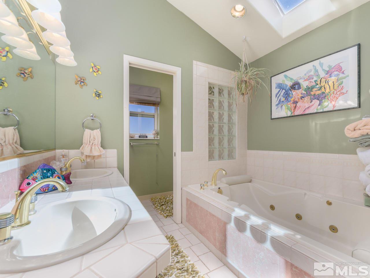 10315 Placerville Road Reno, NV 89508 - Photo 12 of 25 a bathroom with a tub a sink and wooden floor