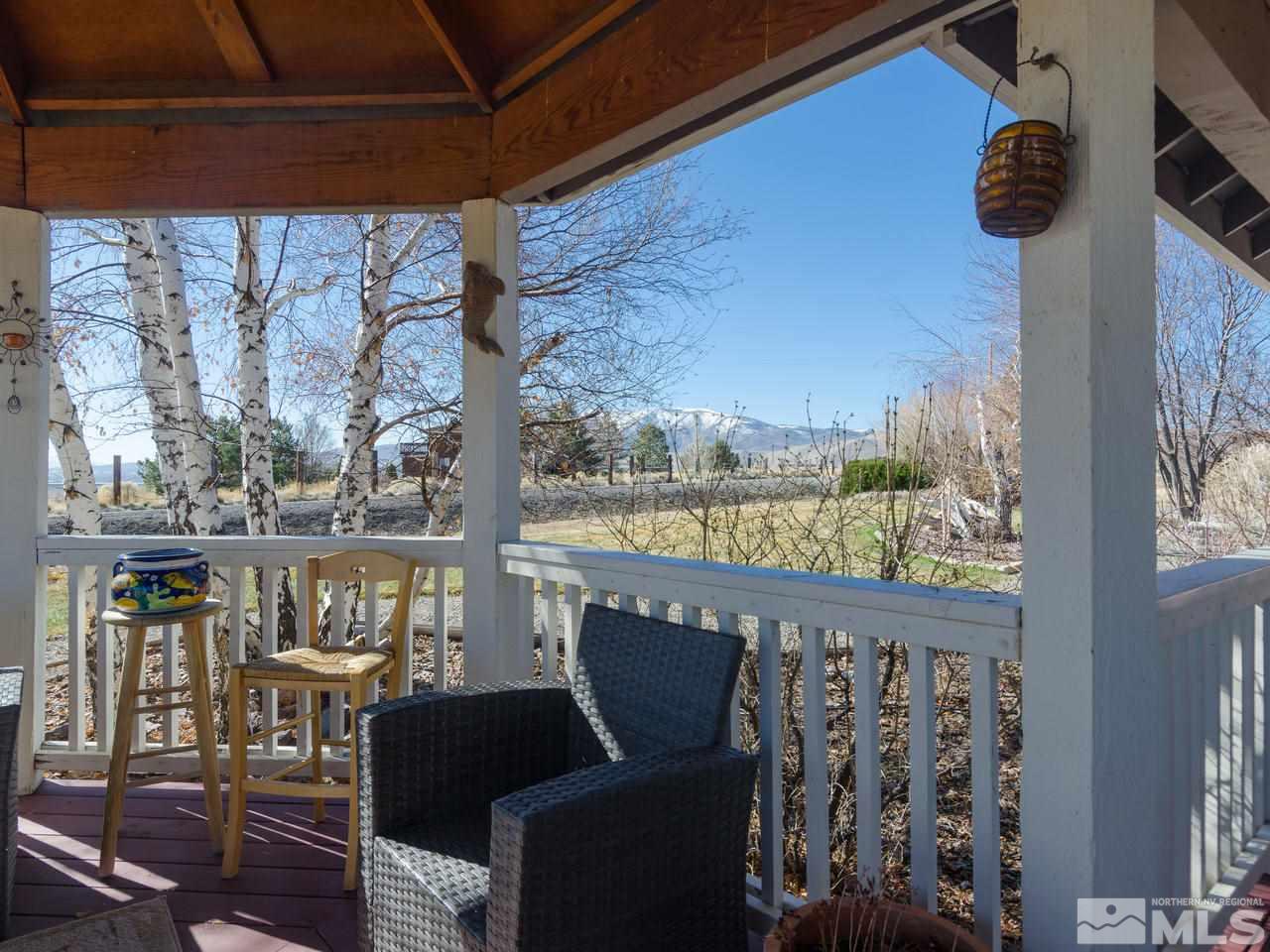 10315 Placerville Road Reno, NV 89508 - Photo 18 of 25 a view of a chairs and table in patio with a lake view
