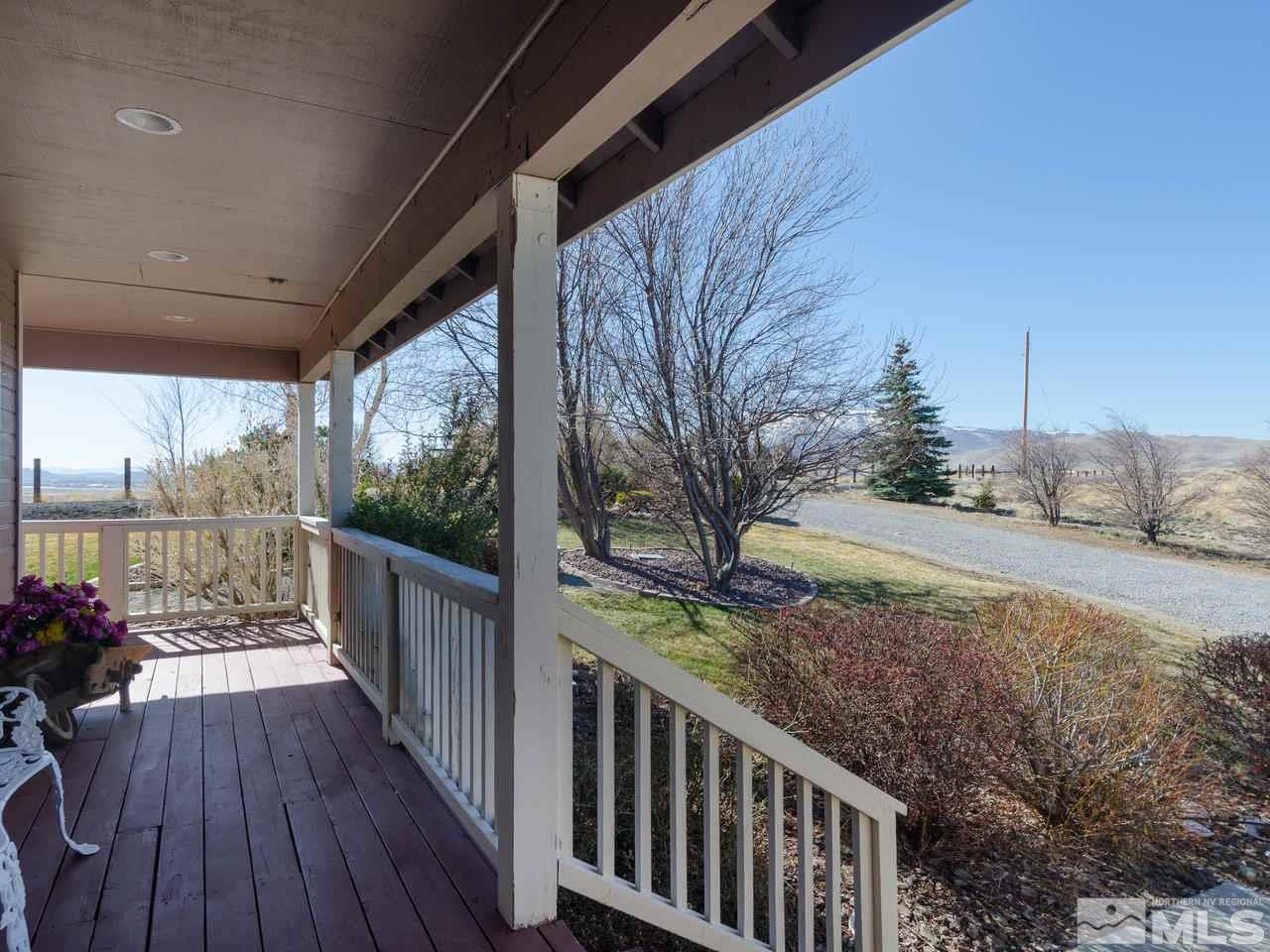 10315 Placerville Road Reno, NV 89508 - Photo 3 of 25 a view of a porch with wooden floor and fence