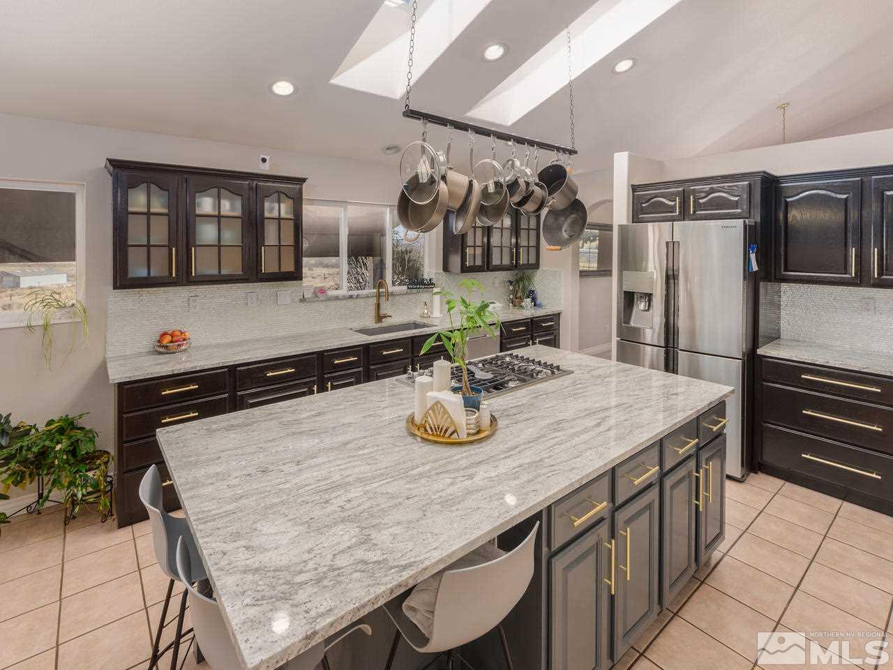 10315 Placerville Road Reno, NV 89508 - Photo 6 of 25 a kitchen with stainless steel appliances granite countertop a kitchen island a stove and a refrigerator