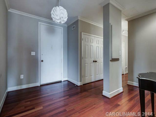 932 Cherokee Road, Unit 3D Charlotte, NC 28207 - Photo 2 of 16 an empty room with wooden floor and entrance