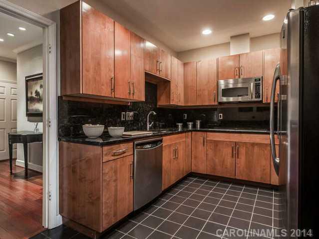 932 Cherokee Road, Unit 3D Charlotte, NC 28207 - Photo 3 of 16 a kitchen with stainless steel appliances granite countertop a stove a sink and a microwave