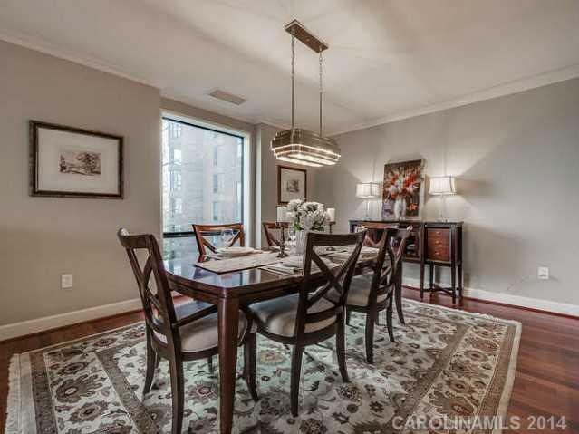 932 Cherokee Road, Unit 3D Charlotte, NC 28207 - Photo 5 of 16 a dining room with furniture a chandelier and window
