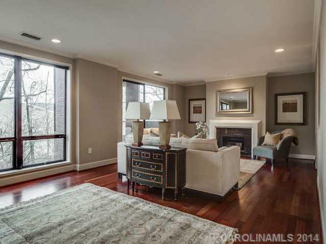 932 Cherokee Road, Unit 3D Charlotte, NC 28207 - Photo 6 of 16 a living room with furniture a fireplace and a large window