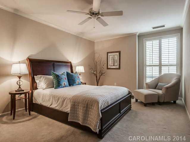 932 Cherokee Road, Unit 3D Charlotte, NC 28207 - Photo 9 of 16 a bedroom with a bed and a couch