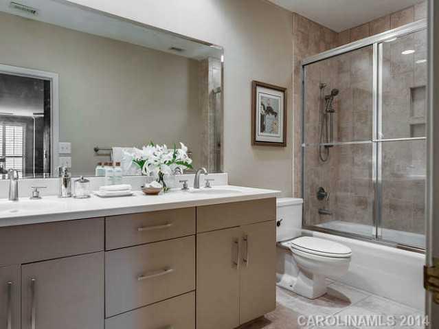 932 Cherokee Road, Unit 3D Charlotte, NC 28207 - Photo 10 of 16 a bathroom with a sink toilet and shower
