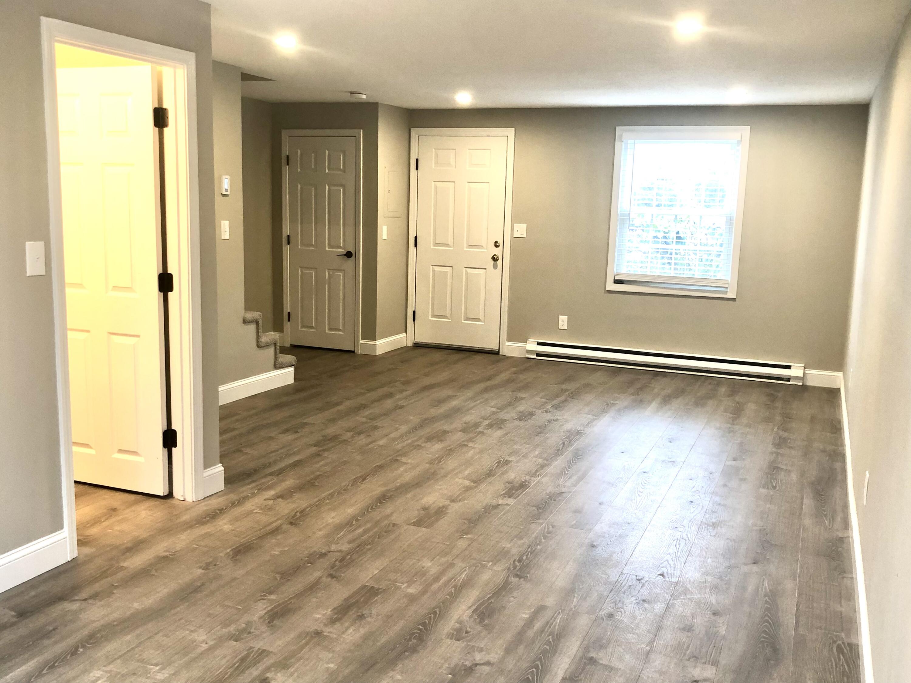 135 West Main Street, Unit 26 Hyannis, MA 02601 - Photo 14 of 29 an empty room with wooden floor and windows