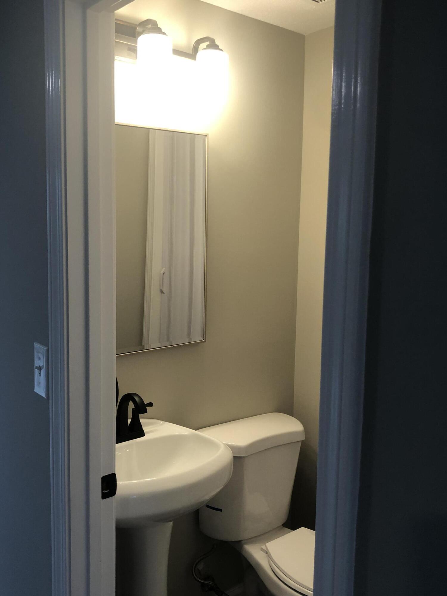 135 West Main Street, Unit 26 Hyannis, MA 02601 - Photo 15 of 29 a bathroom with a toilet a sink and a mirror