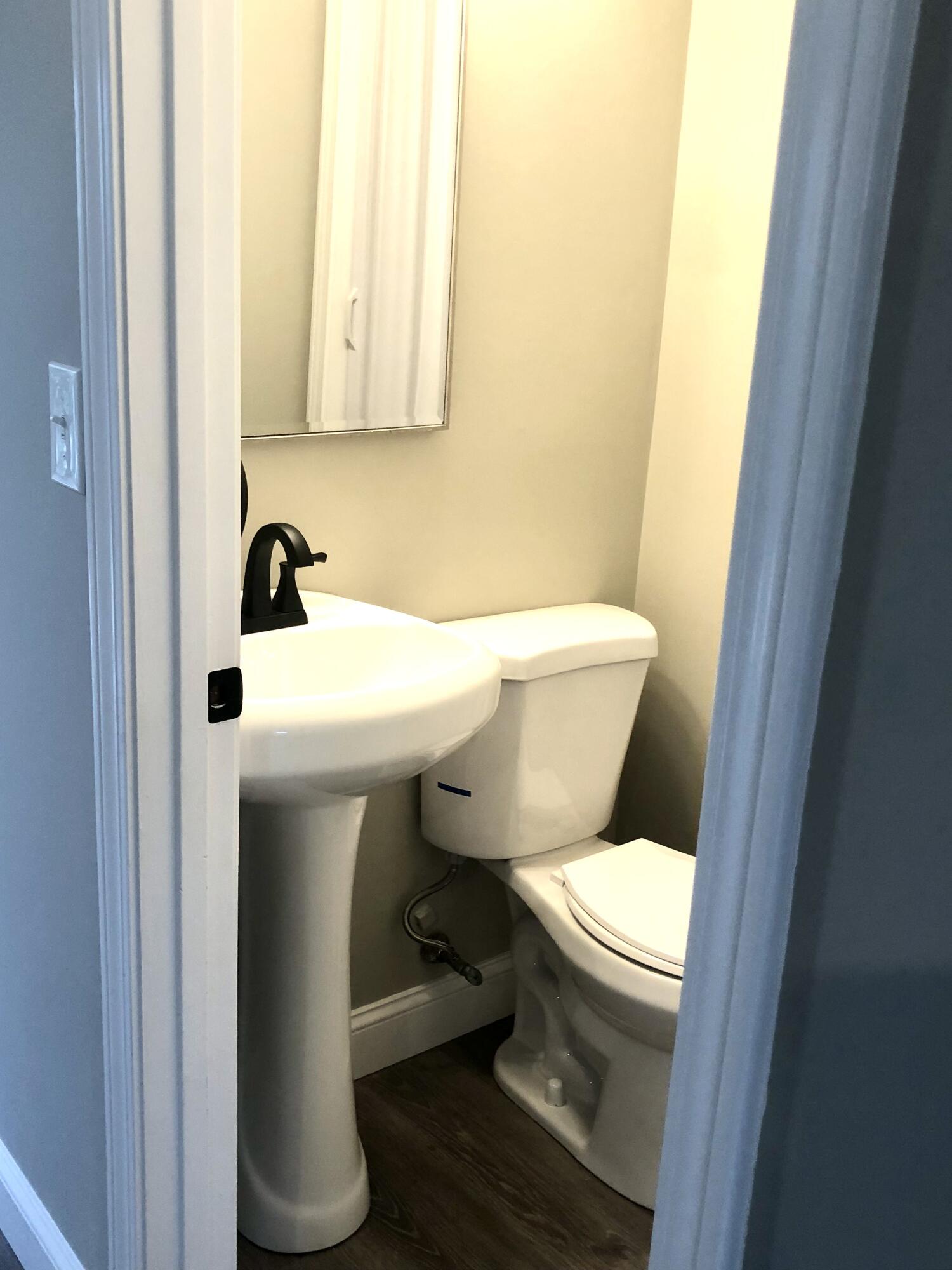 135 West Main Street, Unit 26 Hyannis, MA 02601 - Photo 16 of 29 a white toilet sitting next to a bathroom sink