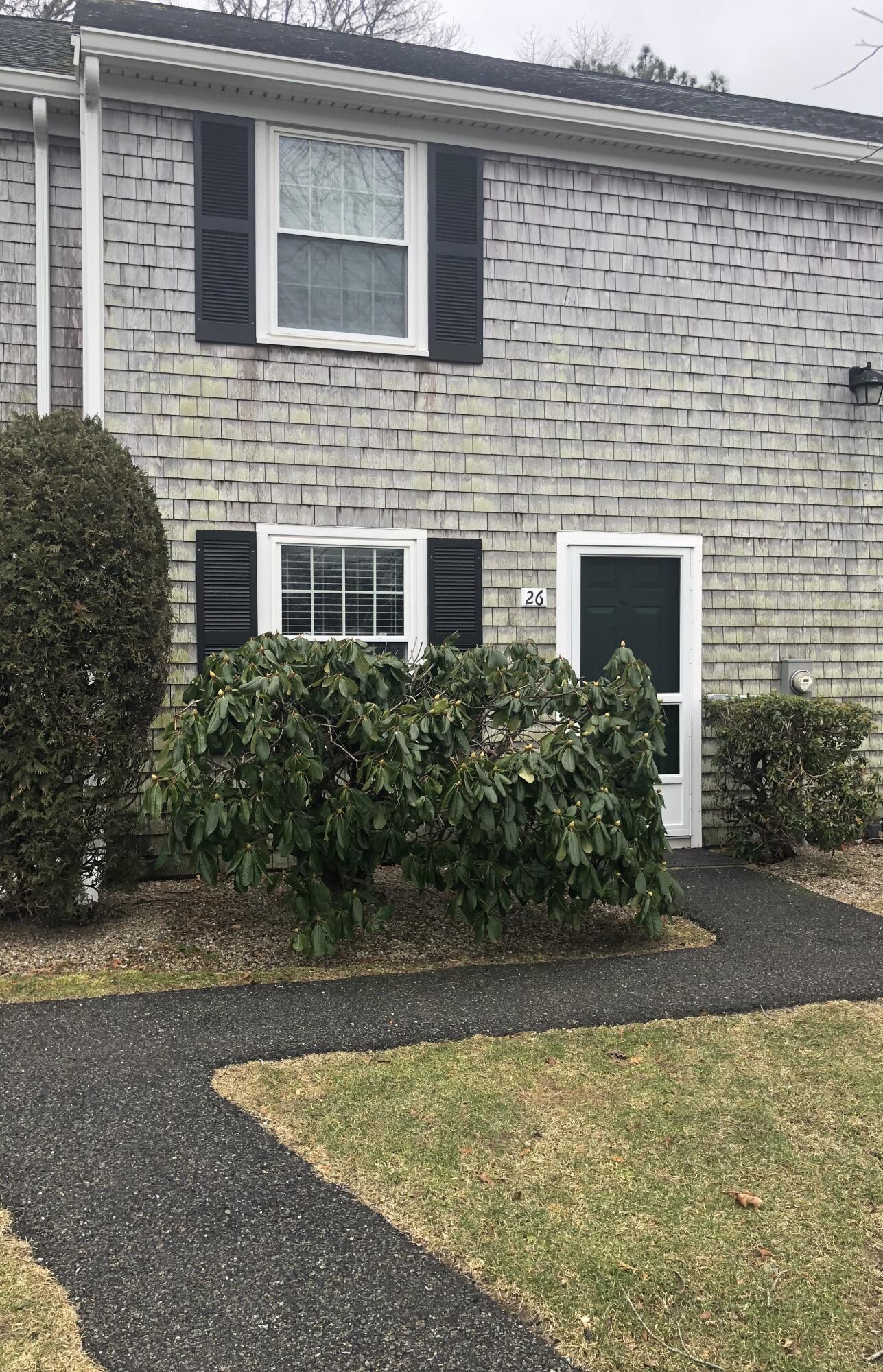 135 West Main Street, Unit 26 Hyannis, MA 02601 - Photo 2 of 29 a front view of a house with a yard