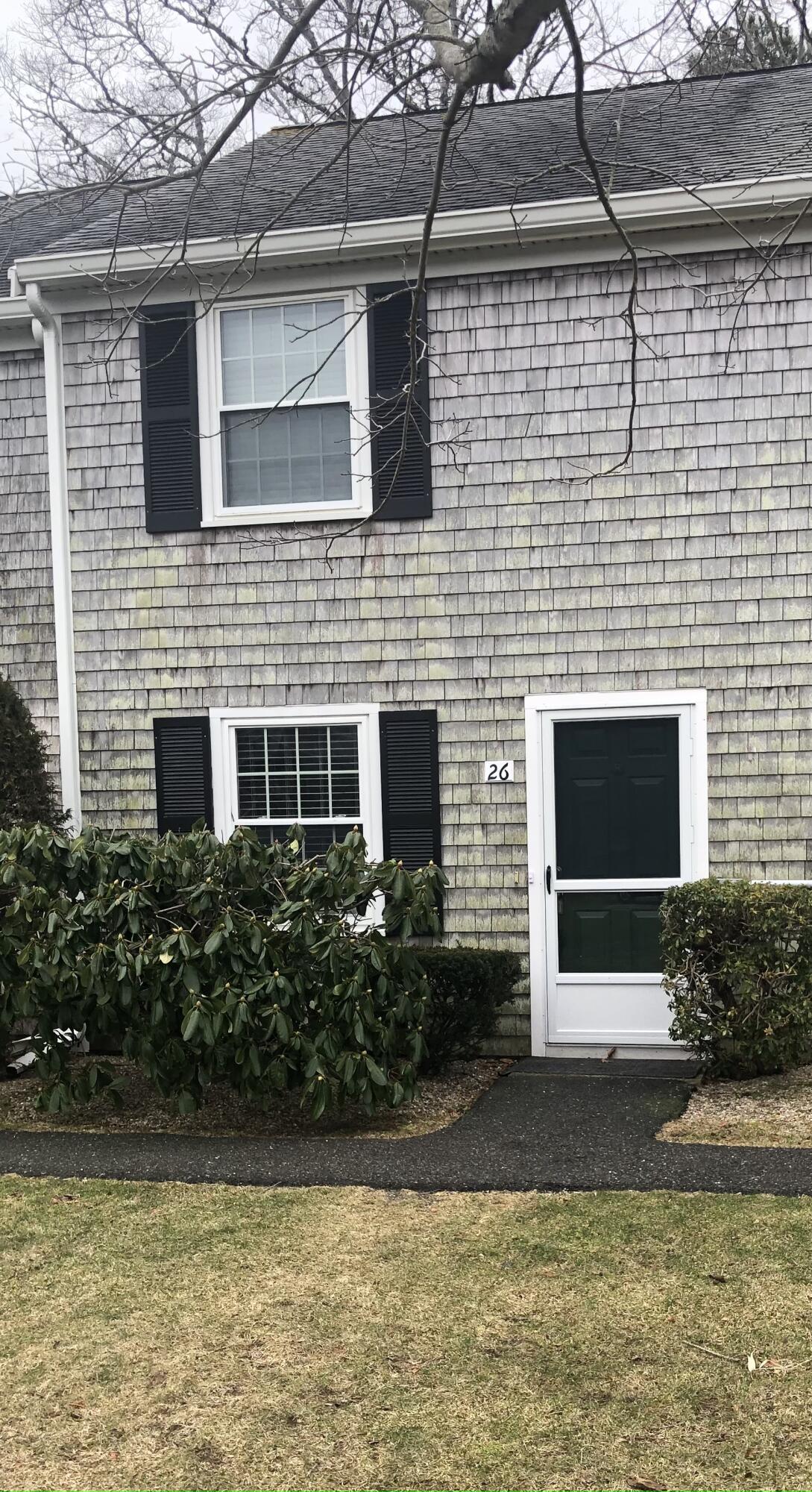 135 West Main Street, Unit 26 Hyannis, MA 02601 - Photo 3 of 29 a front view of a house with a yard