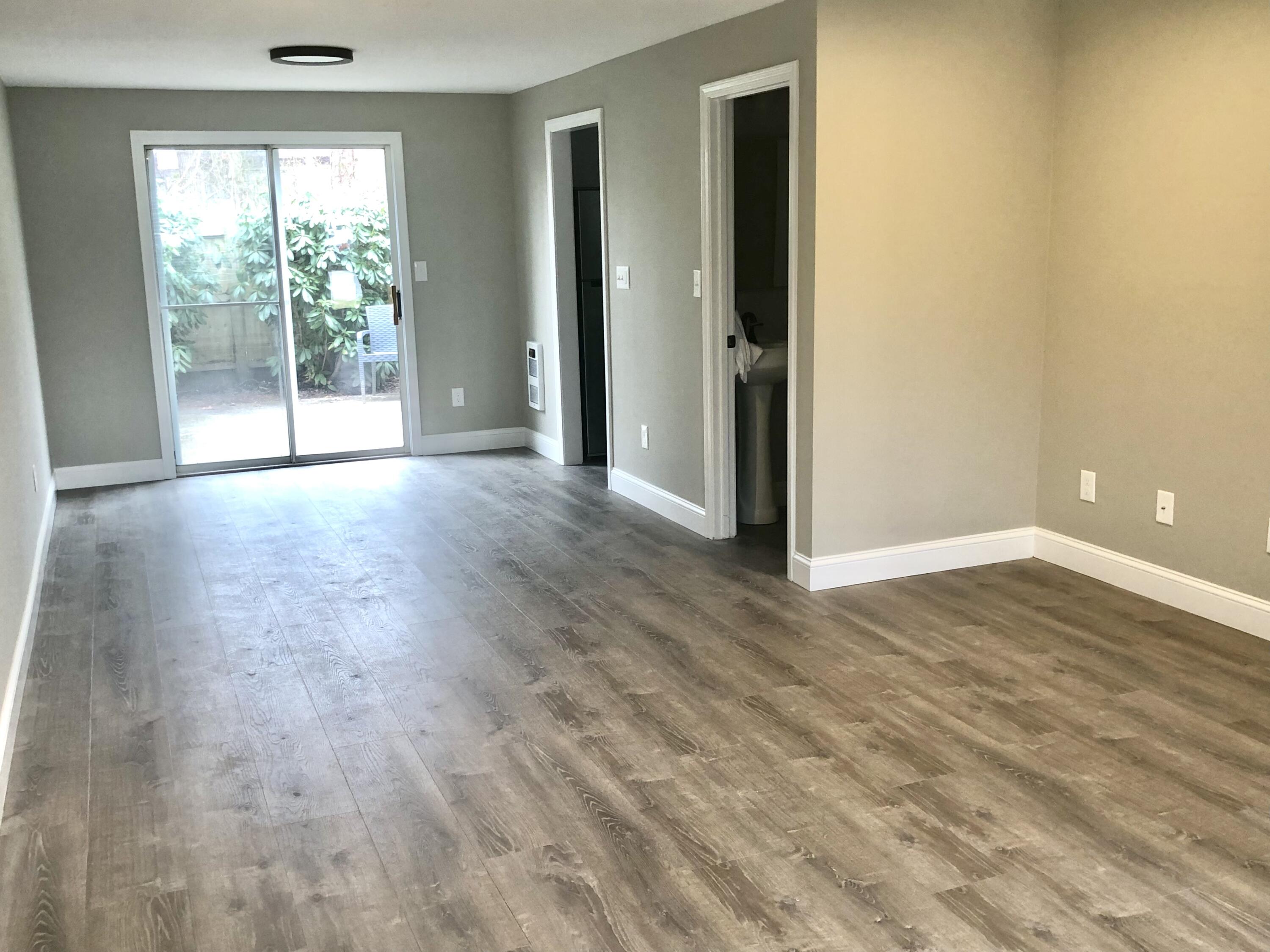 135 West Main Street, Unit 26 Hyannis, MA 02601 - Photo 4 of 29 an empty room with wooden floor and windows
