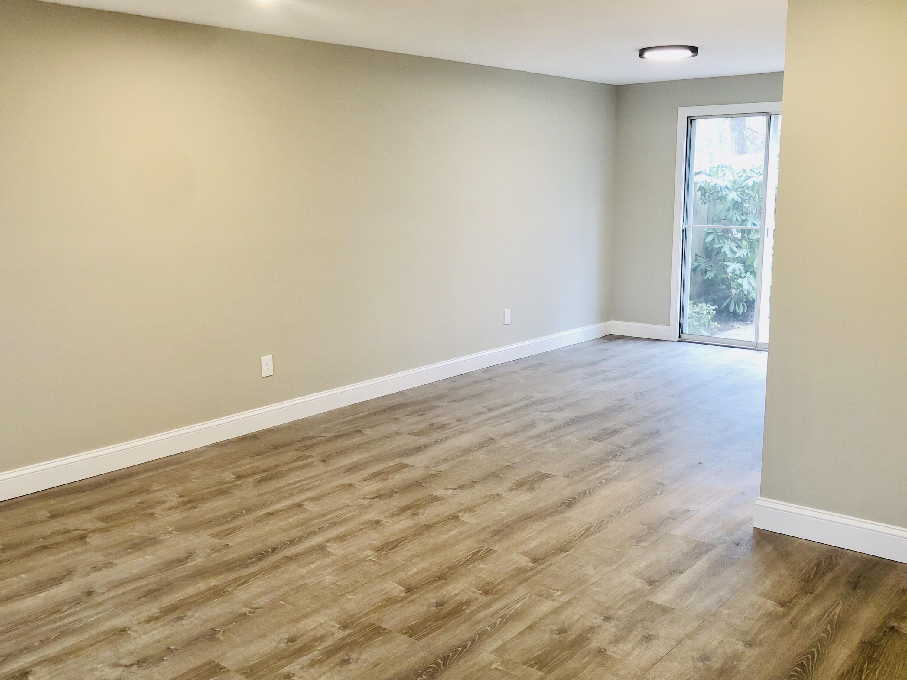 135 West Main Street, Unit 26 Hyannis, MA 02601 - Photo 6 of 29 a view of an empty room with wooden floor and a window