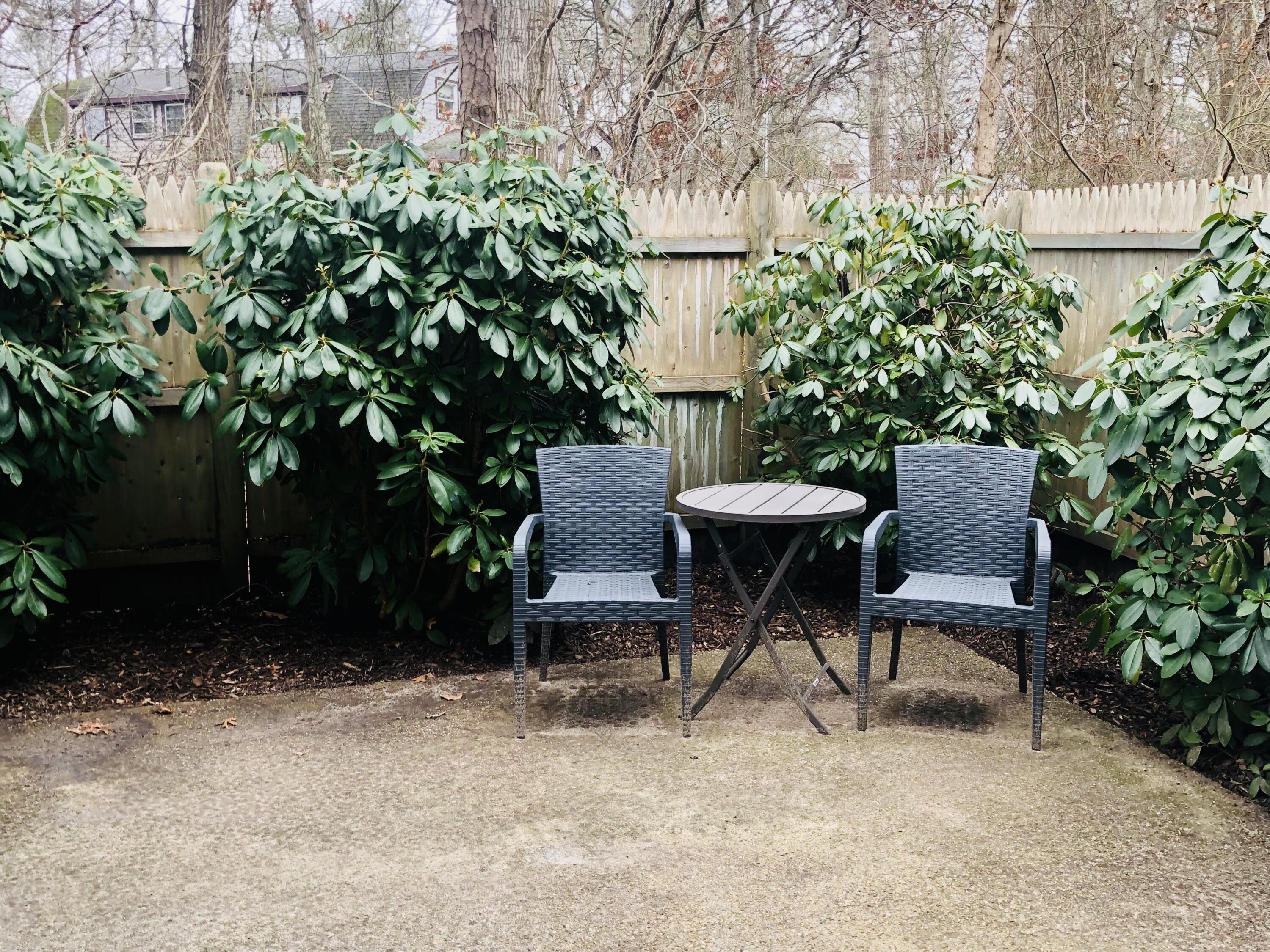 135 West Main Street, Unit 26 Hyannis, MA 02601 - Photo 7 of 29 a view of a chairs and table in a backyard